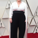 Melissa McCarthy in a jumpsuit and cape.